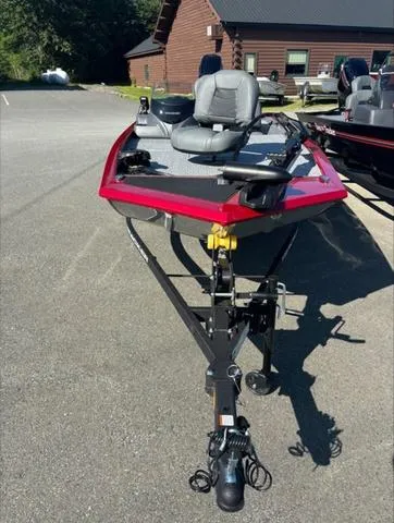 Slide: The Image of 2024 Tracker Pro 170 boat, red exterior, parked outdoors. - 9