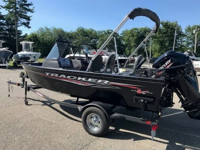 Slide: The Image of 2024 Tracker Pro Guide™ V-16 WT boat on trailer, parked outdoors. - 10