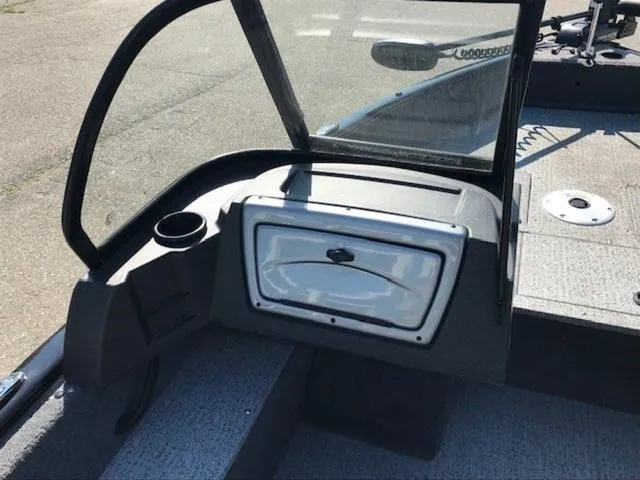 Slide: The Image of 2024 Tracker Pro Guide™ V-16 WT boat interior with windshield and storage compartment. - 5