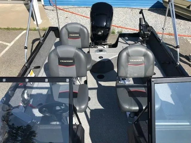 Slide: The Image of 2024 Tracker Pro Guide™ V-16 WT boat interior with seating and motor. - 6