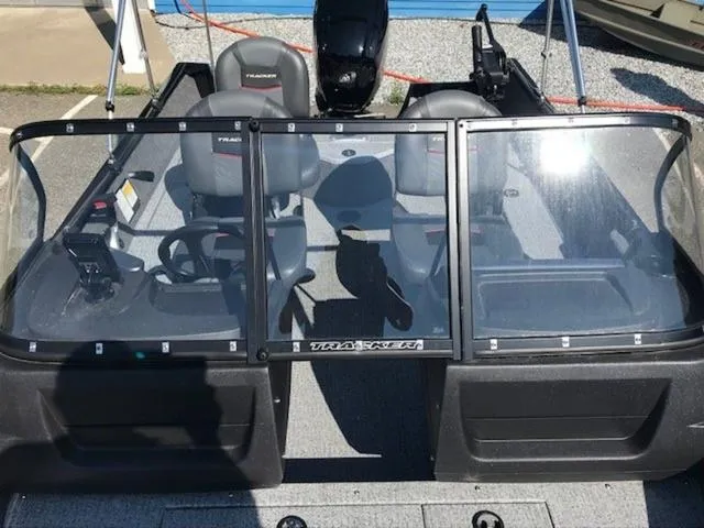 Slide: The Image of 2024 Tracker Pro Guide V-16 WT boat interior with dual seats and windshield. - 7