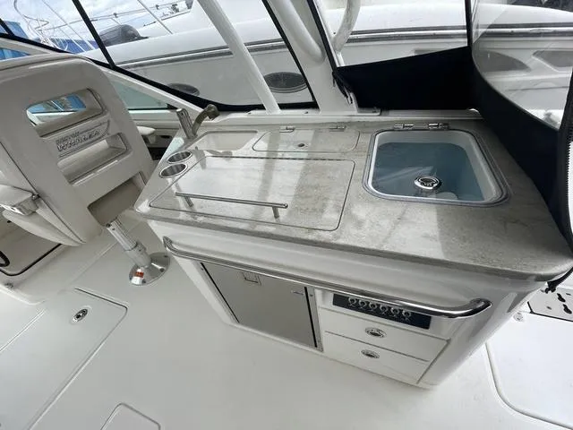 Slide: The Image of 2016 Boston Whaler 320 Vantage boat interior with sink and storage. - 12