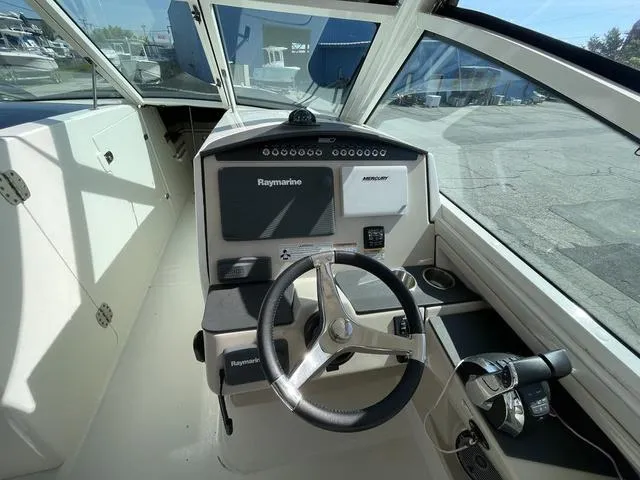 Slide: The Image of Cockpit of 2016 Boston Whaler 320 Vantage with Raymarine navigation system. - 14