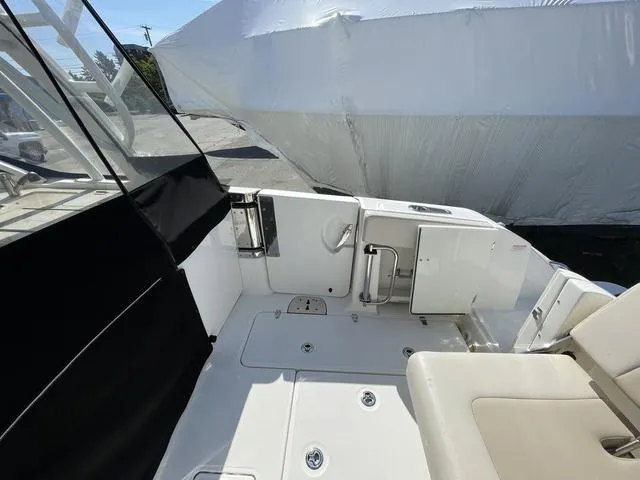 Slide: The Image of 2016 Boston Whaler 320 Vantage boat interior with seating and storage compartments. - 16