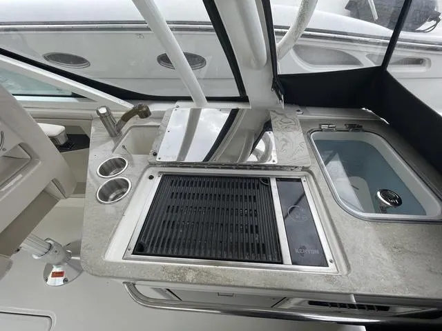 Slide: The Image of 2016 Boston Whaler 320 Vantage boat kitchen area with grill and sink. - 19
