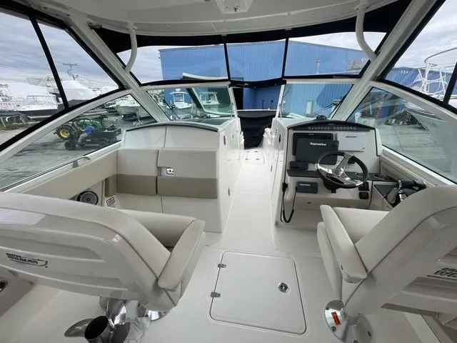 Slide: The Image of 2016 Boston Whaler 320 Vantage boat interior with helm and seating area. - 21