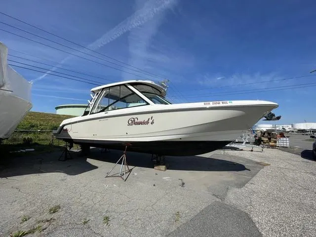 Slide: The Image of 2016 Boston Whaler 320 Vantage boat on dry dock under clear blue sky. - 3
