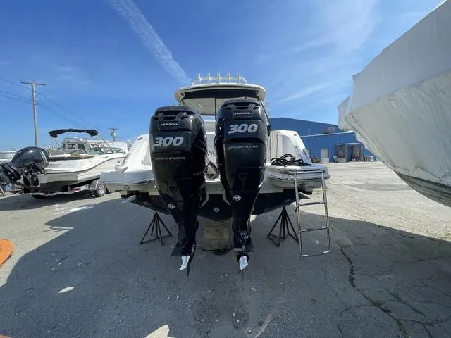Slide: The Image of 2016 Boston Whaler 320 Vantage with twin 300 horsepower engines, parked outdoors. - 6