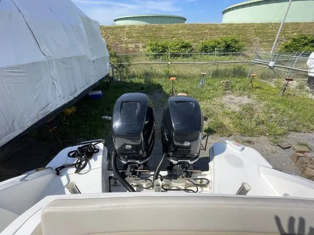 Slide: The Image of 2016 Boston Whaler 320 Vantage with dual outboard engines, parked outdoors. - 7