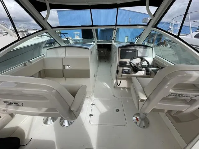 Slide: The Image of 2016 Boston Whaler 320 Vantage boat interior with helm and seating area. - 8