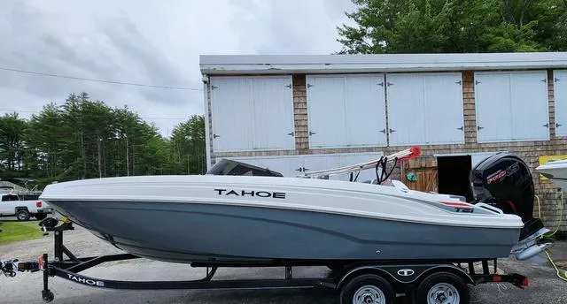 Slide: The Image of 2024 Tahoe T21 boat on trailer, parked outdoors near a building. - 5