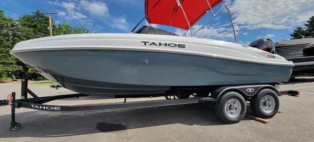 Slide: The Image of 2024 Tahoe T21 boat on trailer with red canopy, parked outdoors under blue sky. - 8