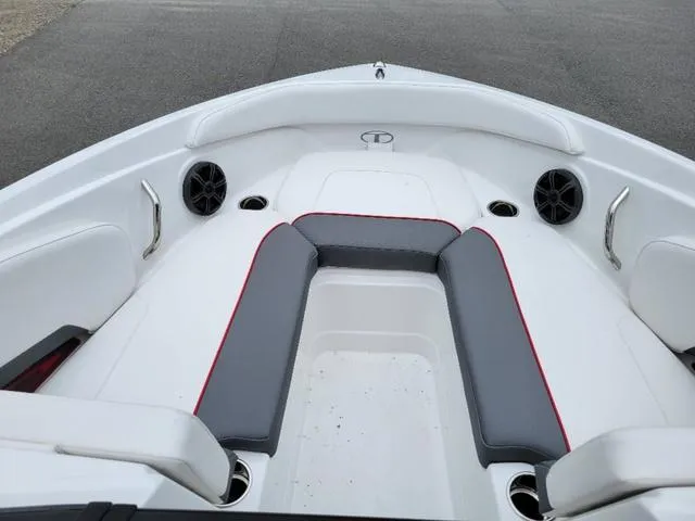 Slide: The Image of 2024 Tahoe 210 S boat interior with gray and red seating, cup holders, and speakers. - 14