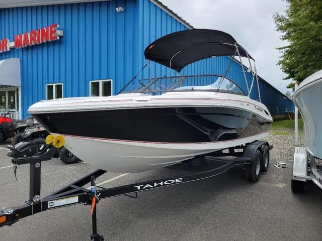 Slide: The Image of 2024 Tahoe 210 S boat on trailer outside marine dealership. - 3