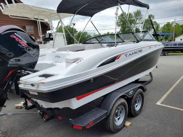 Slide: The Image of 2024 Tahoe 210 S boat on trailer, black and white design, outdoor display. - 5