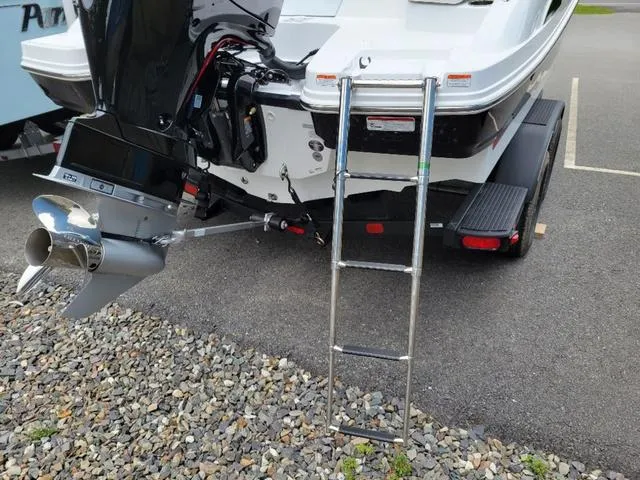 Slide: The Image of 2024 Tahoe 210 S boat with ladder and outboard motor on trailer. - 7