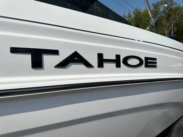 Slide: The Image of 2024 Tahoe T21 boat, close-up of logo on sleek white exterior. - 3