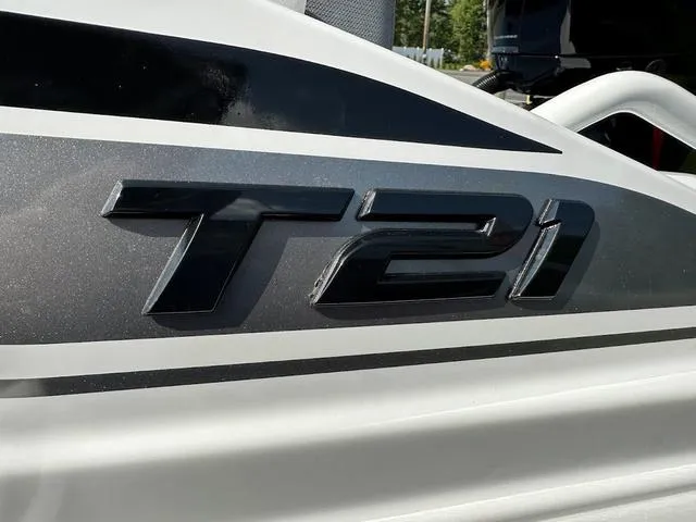 Slide: The Image of 2024 Tahoe T21 boat logo in sleek black and silver design. - 4