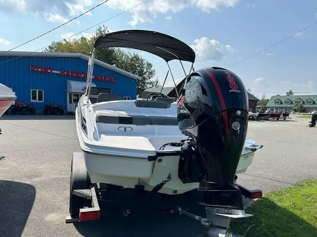 Slide: The Image of 2024 Tahoe T21 boat with outboard motor at a marina under a clear sky. - 5