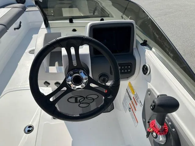 Slide: The Image of 2024 Tahoe T21 boat dashboard with steering wheel and control panel. - 9