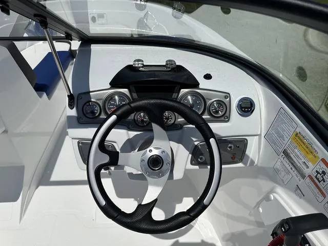 Slide: The Image of 2024 Tahoe 200 S boat dashboard with steering wheel and gauges. - 6