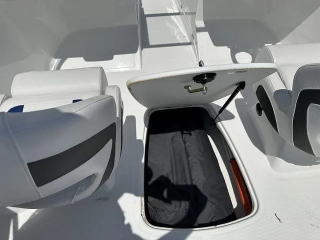 Slide: The Image of 2024 Tahoe 200 S boat interior with open storage compartment and seating. - 8