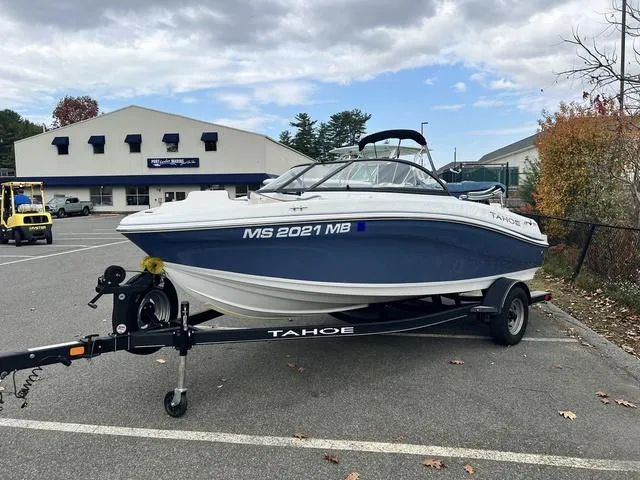 Slide: The Image of 2021 Tahoe 450 TS boat on trailer in parking lot, cloudy sky background. - 3