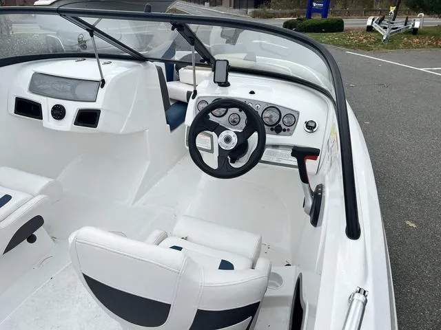 Slide: The Image of 2021 Tahoe 450 TS boat interior with steering wheel and dashboard controls. - 6