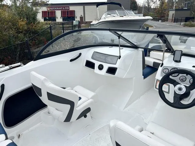 Slide: The Image of 2021 Tahoe 450 TS boat interior with modern dashboard and seating. - 7