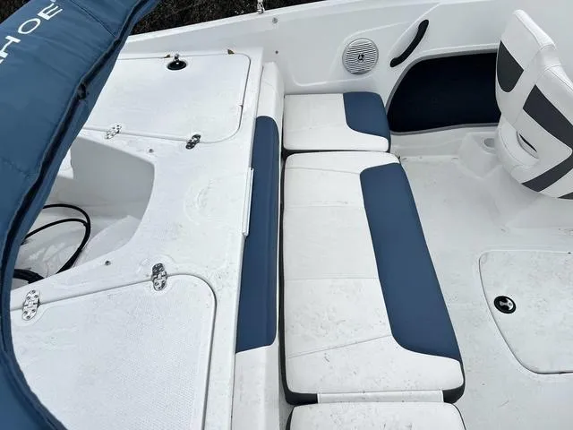 Slide: The Image of 2021 Tahoe 450 TS boat interior with white and blue seating and storage compartments. - 8