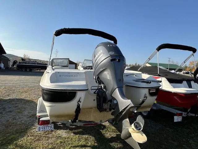 Slide: The Image of 2015 Stingray 191RX boat with Yamaha outboard motor, parked outdoors. - 12