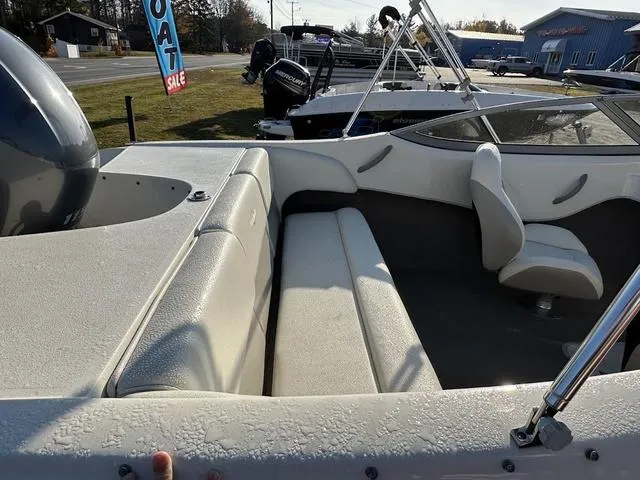 Slide: The Image of 2015 Stingray 191RX boat interior with seating and steering wheel, displayed outdoors. - 14