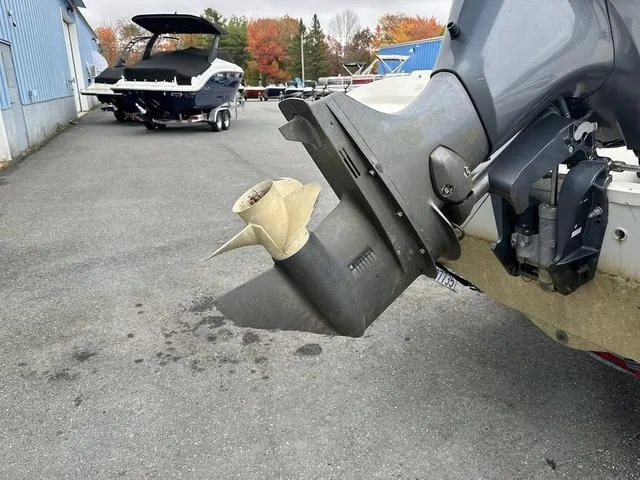 Slide: The Image of 2015 Stingray 191RX boat propeller and motor detail in a parking area. - 4