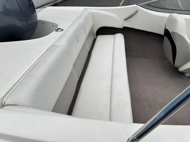 Slide: The Image of 2015 Stingray 191RX boat interior with white seating and carpeted floor. - 8