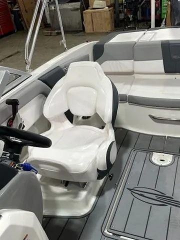 Slide: The Image of 2021 Chaparral 19 SSi boat interior with white seating and gray accents. - 12