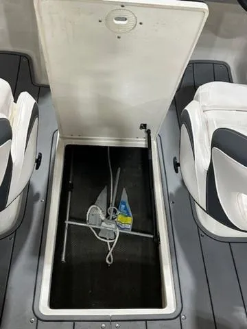 Slide: The Image of Open storage compartment in 2021 Chaparral 19 SSi boat, showing anchor and rope. - 13