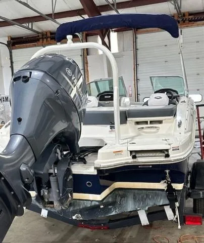 Slide: The Image of 2021 Chaparral 19 SSi boat with Yamaha outboard motor in a garage. - 4