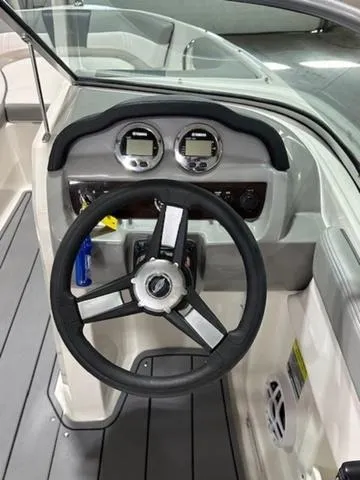 Slide: The Image of 2021 Chaparral 19 SSi boat dashboard with steering wheel and gauges. - 8