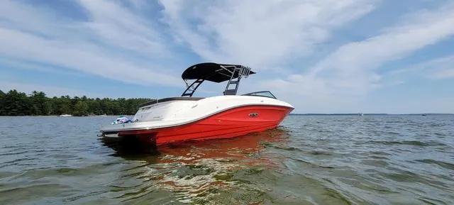 Slide: The Image of 2019 Sea Ray SPX 230 boat on calm water under a clear sky. - 3