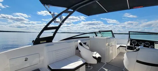 Slide: The Image of 2019 Sea Ray SPX 230 boat interior with seating, open water view, and clear sky. - 4