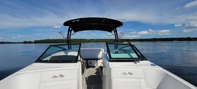 Slide: The Image of 2019 Sea Ray SPX 230 boat on a calm lake under a clear blue sky. - 5