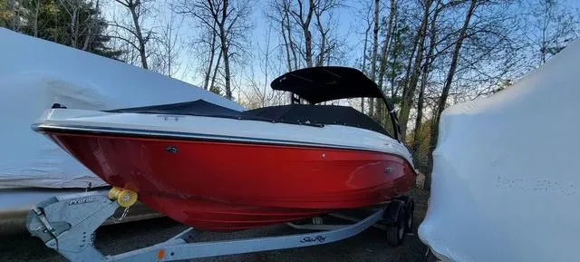 Slide: The Image of 2019 Sea Ray SPX 230 boat in red on a trailer, surrounded by trees. - 6