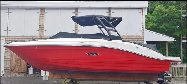 Slide: The Image of 2019 Sea Ray SPX 230 boat with red hull and black canopy. - 9
