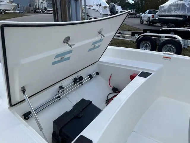 Slide: The Image of 2023 Mako Pro Skiff 15 CC storage compartment open, showcasing interior features and equipment. - 4