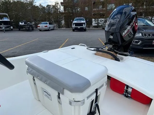 Slide: The Image of 2023 Mako Pro Skiff 15 CC with Mercury outboard motor in parking lot. - 6