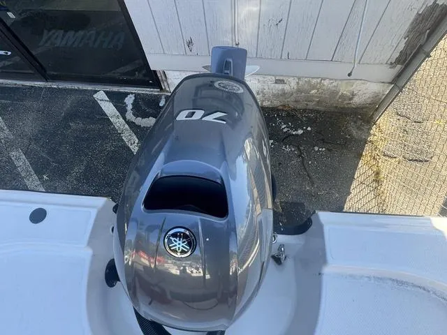 Slide: The Image of 2024 Edgewater 158CS boat with Yamaha 70 outboard motor, parked outdoors. - 10