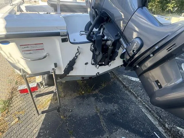 Slide: The Image of 2024 Edgewater 158CS boat stern with motor and boarding ladder. - 11