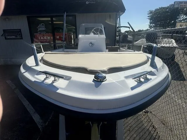 Slide: The Image of 2024 Edgewater 158CS boat, front view, displayed outdoors near a fence. - 3