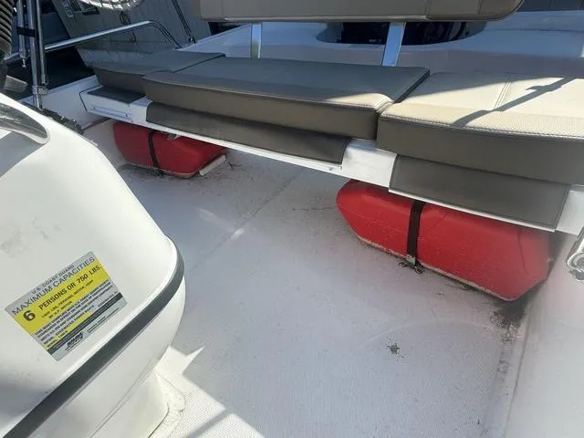 Slide: The Image of 2024 Edgewater 158CS boat interior with seating and red flotation devices. - 8