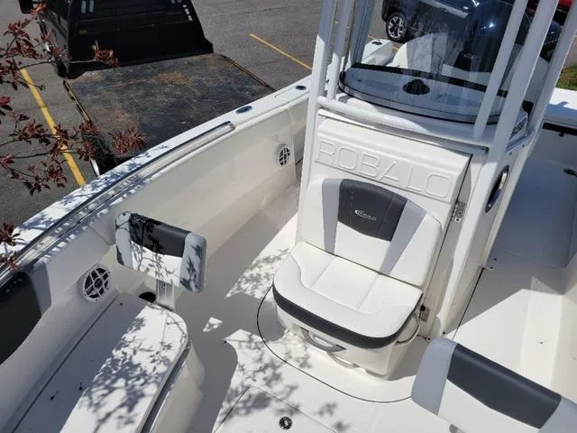 Slide: The Image of 2024 Robalo R232EX boat interior with seating and console, showcasing modern design and comfort. - 10